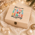 Personalised wooden Christmas Eve box with 'Olivia Baby's First Christmas' colourful design