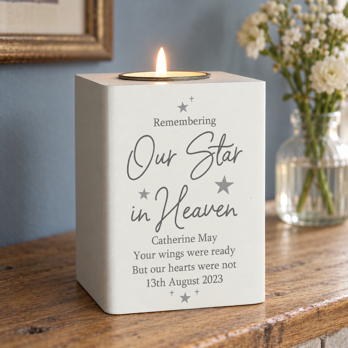 Personalised Our Star in Heaven memorial tea light holder with a lit candle