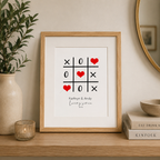 Personalised couples print with a noughts and crosses grid of hearts and names, framed