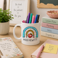 Personalised teacher mug with rainbow, apple and pencil design and the name 'Miss Hewitt'