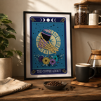 Framed tarot style print 'The Coffee Addict' with skeleton hands and coffee cup, in a kitchen