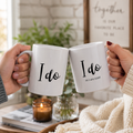 Funny couples wedding mug set reading 'I do' and 'I do as I am told' held by a couple