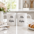 Personalised wedding mug set reading 'Mr Hipkiss' and 'Mrs Hipkiss' on a kitchen worktop