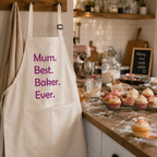 Cream personalised baking apron with bold pink lettering