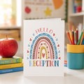 Personalised starting reception card with a boho rainbow and 'Hello Reception' text, on a classroom desk