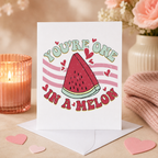 Funny 'You're one in a melon' Valentine's card with watermelon design, shown on a table