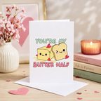 Funny 'You're my butter half' Valentine's card with butter and toast design, shown on a table