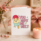 Funny 'You make me melt' Valentine's card with melting ice lolly design, shown on a table