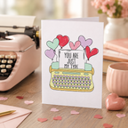 Valentine's card with a typewriter and heart balloons reading 'You are just my type'