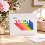 Bright 'Yes, Women Can' card with bold rainbow lettering
