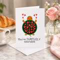 Funny Valentine's card with a turtle and hearts, reading 'You're turtlely adorable'