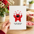 Funny monster Valentine's card with hearts beside a gift box and roses