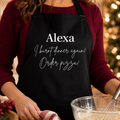 Black slogan apron reading 'Alexa I Burnt Dinner Again Order Pizza'