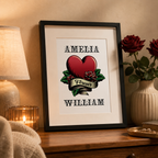 Personalised tattoo style couples print with a heart, roses, banner and two names in a black frame