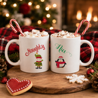 Naughty and Nice Christmas mug set, two white mugs with elf and penguin designs and candy canes