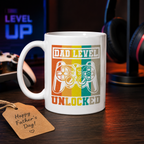 White mug with retro game controller and 'Dad level unlocked'