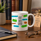 White mug with funny 'Shit Dad Says' speech-bubble sayings, beside a Father's Day gift tag
