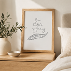 Minimalist 'You tickle my fancy' feather print in a black frame