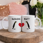Pair of personalised penguin mugs with the names 'Natasha' and 'Matt' and a red heart