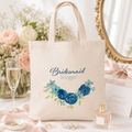 Personalised tote bag printed 'Bridesmaid Imogen' with a blue floral design, natural canvas