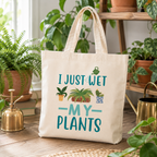 Natural cotton tote bag with 'I Just Wet My Plants' slogan and potted plant design, on a plant shelf