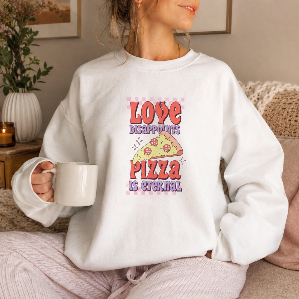 White sweatshirt with retro 'Love disappoints pizza is eternal' design