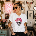 White t-shirt with pink floral skull design topped with roses