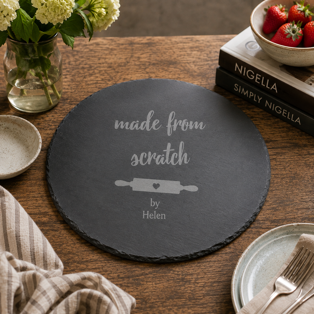 Engraved slate baking board featuring a rolling pin design, styled with eggs and baking accessories.