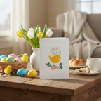 Easter card with chick design on a table with Easter decorations