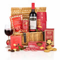 Decadent Delights Hamper with a bottle of Water Stop Shiraz, mince pies, ginger thins, pralines and candy canes in a wicker basket