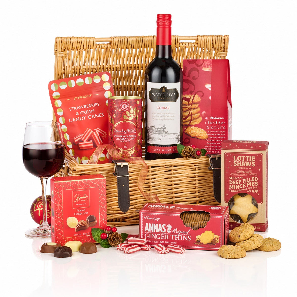 Decadent Delights Hamper with a bottle of Water Stop Shiraz, mince pies, ginger thins, pralines and candy canes in a wicker basket