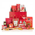 The Redsleeves Hamper (Alcohol Free) with mince pies, popcorn, ginger thins, tea, jam and truffles by a red Christmas gift box