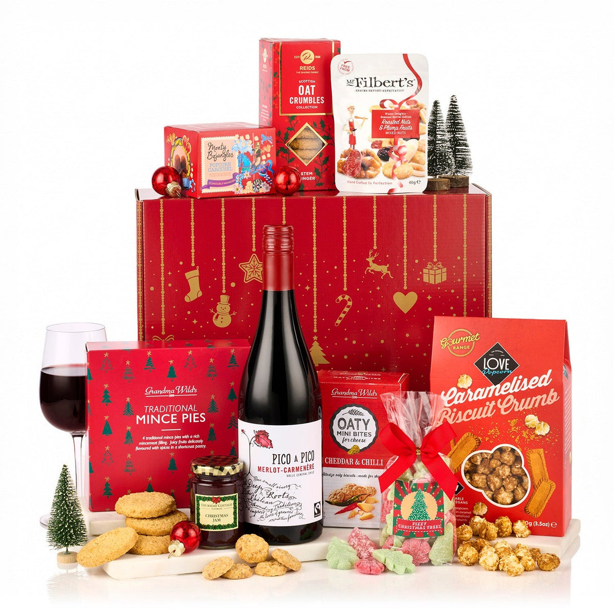 The Redsleeves Hamper with a bottle of Pico a Pico Merlot Carmenère, mince pies, popcorn, oat crumbles and jam by a red Christmas gift box