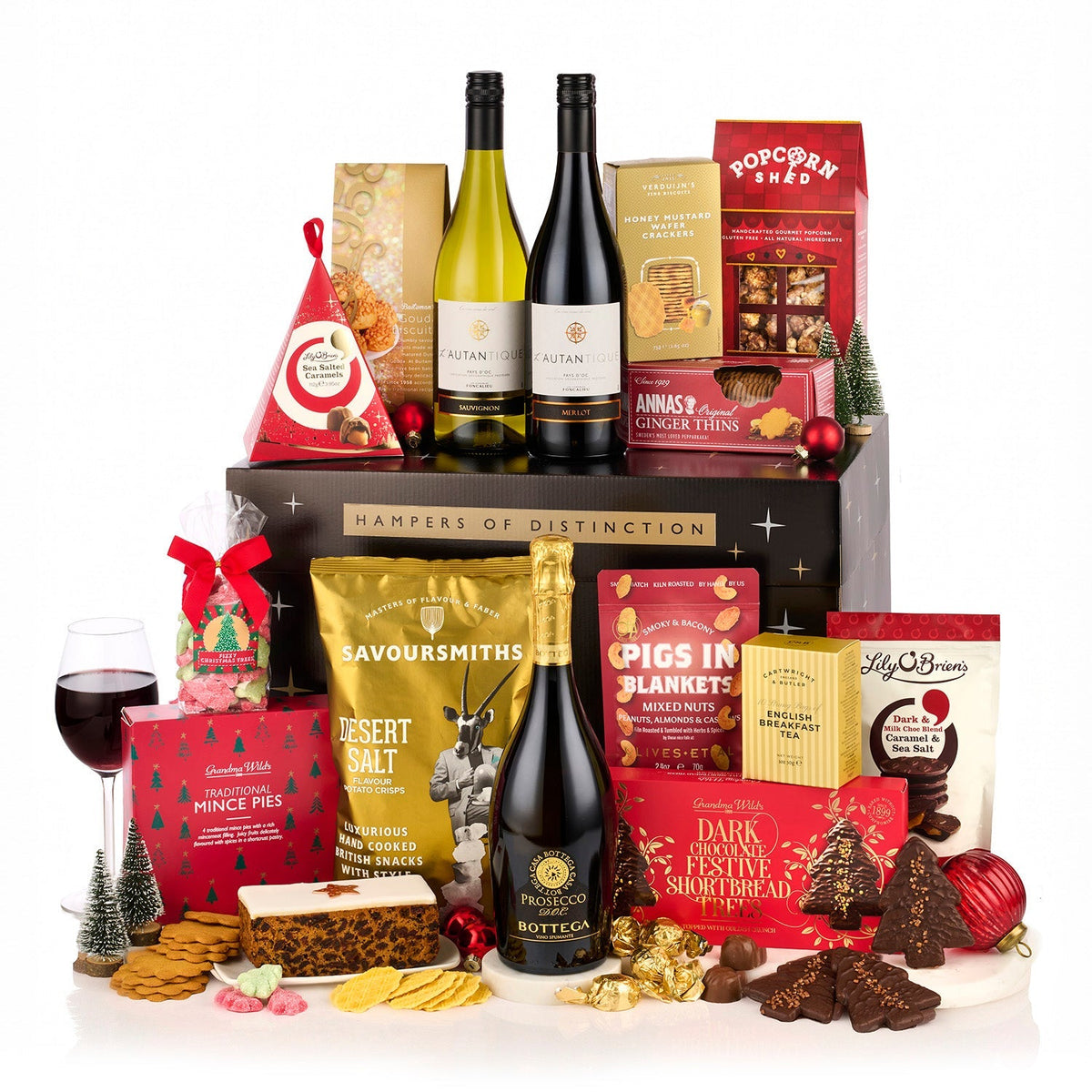 The Excelsior Gift Box Hamper with Bottega Prosecco, red and white wine, mince pies, fruit cake and chocolates by a black gift box