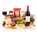 The Decadent Deli Hamper with a bottle of Rowlands Brook Shiraz, four cheddars, crackers, chutney and peanuts in a woven basket