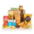 Gluten Free Hamper with olives, chilli ginger crackers, crisps, vanilla popcorn, biscuits and chocolate in front of a kraft gift box