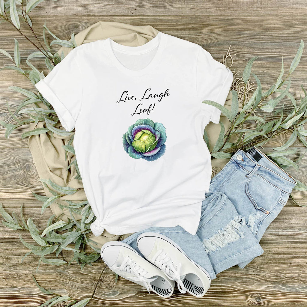 Close-up of the watercolour cabbage and 'Live Laugh Leaf' slogan on a t-shirt