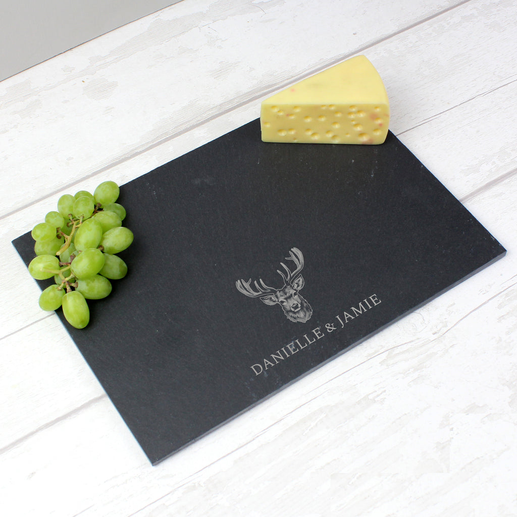Personalised stag slate placemat on a table with a knife and fork