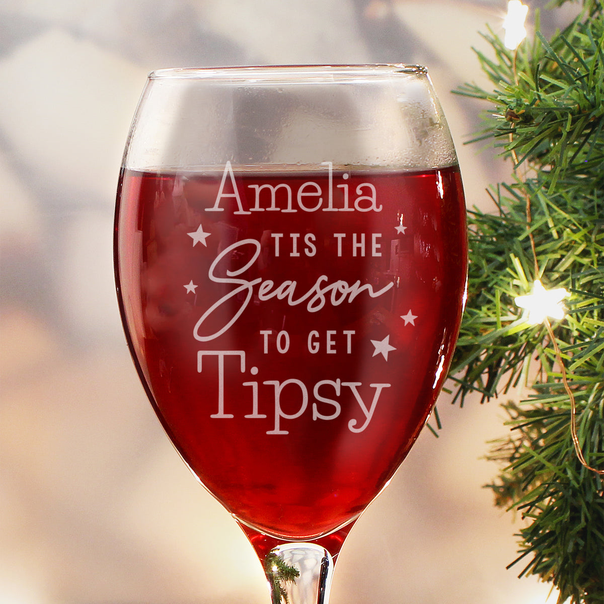 Personalised 'Tis the Season to Get Tipsy wine glass by the Christmas tree