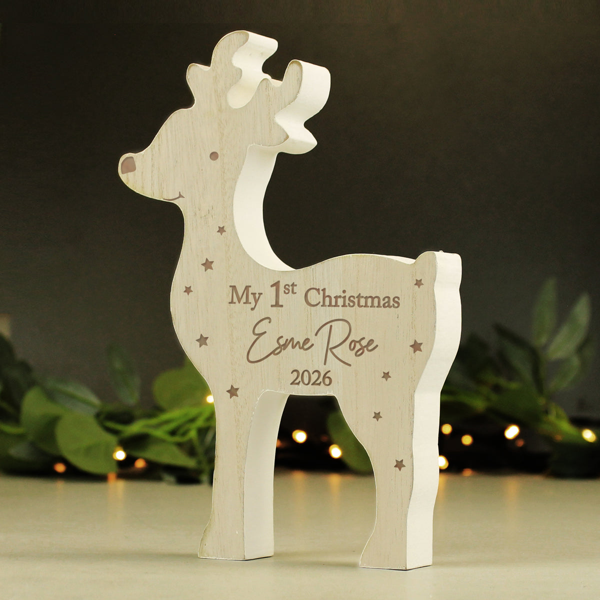 Personalised My 1st Christmas wooden reindeer standing on a mantelpiece