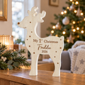 Personalised My 1st Christmas wooden reindeer standing on a sideboard by the tree