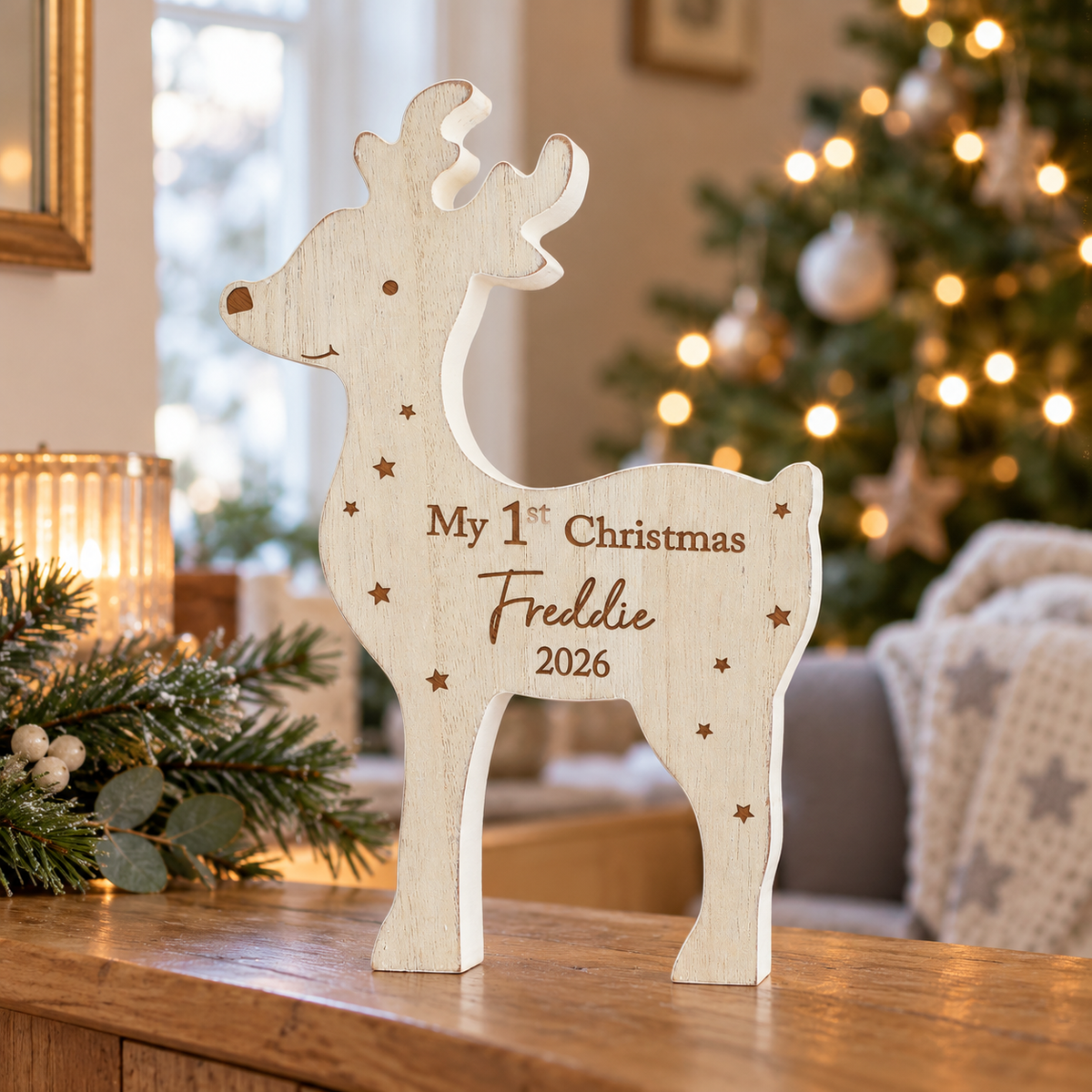 Personalised My 1st Christmas wooden reindeer standing on a sideboard by the tree