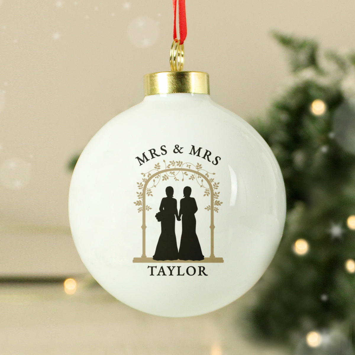 Personalised Mrs & Mrs ceramic Christmas bauble hanging on the tree