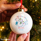 Personalised The Snowman My 1st Christmas Ceramic Bauble hanging on a Christmas tree