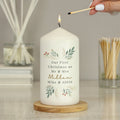 Personalised Christmas Foliage Pillar Candle lit on a wooden table