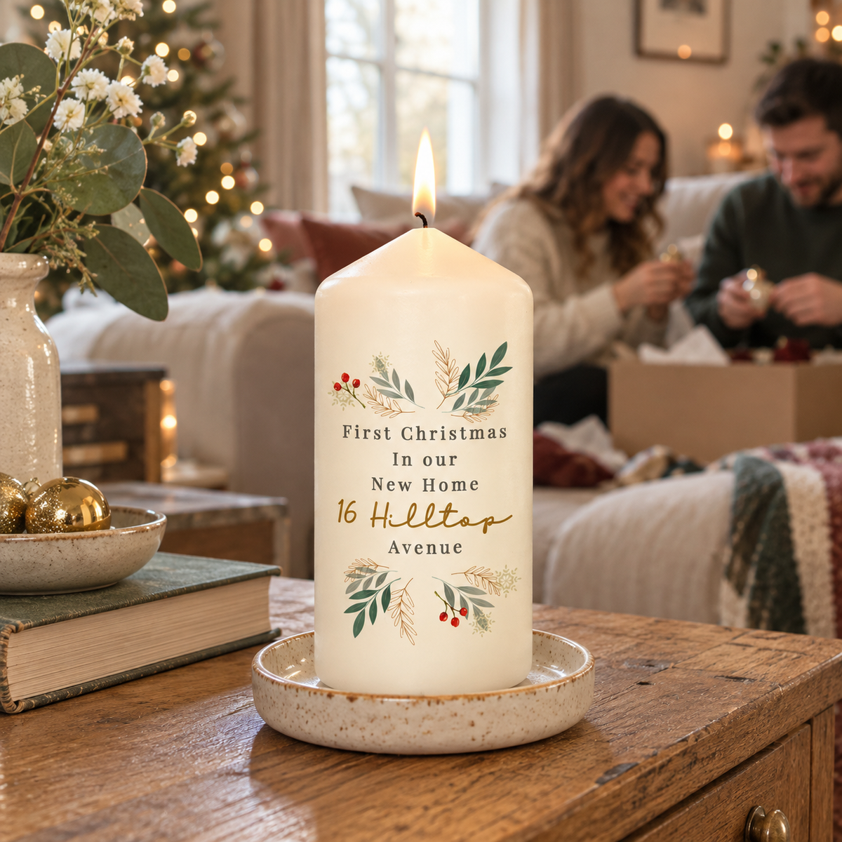Personalised Christmas Foliage Pillar Candle lit in a new home at Christmas