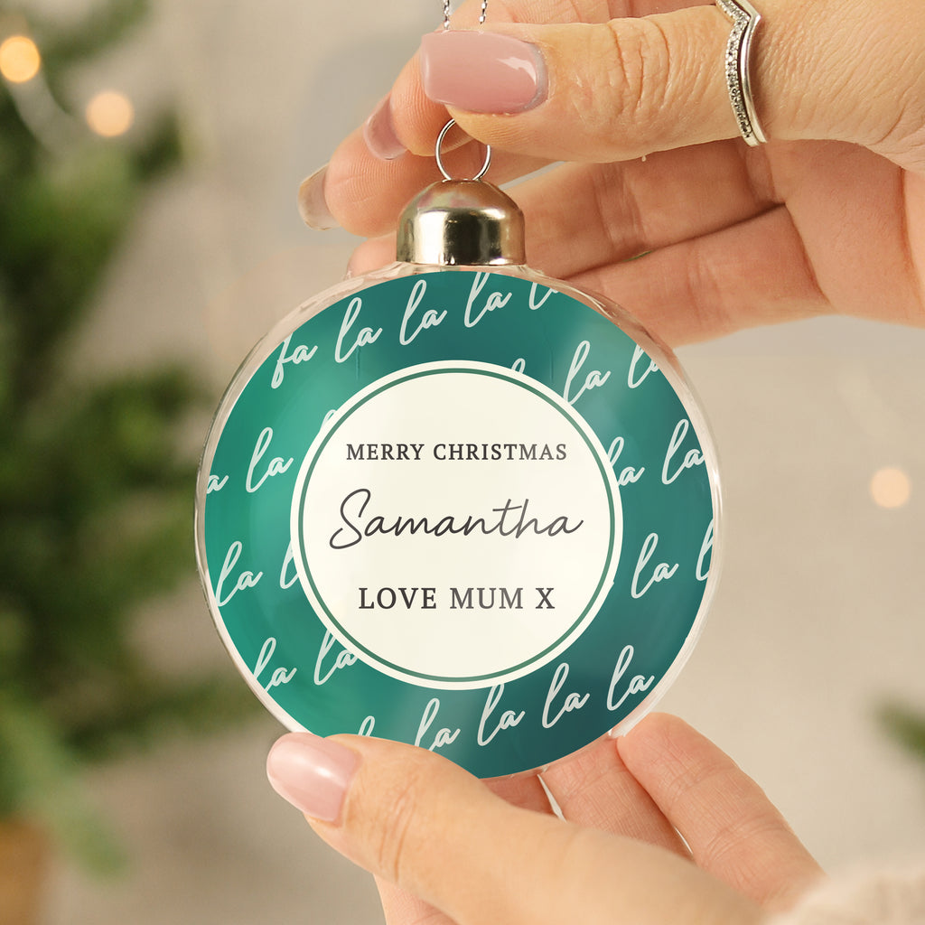 Personalised Fa La La Glass Bauble hanging on a Christmas tree