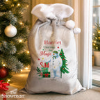Personalised The Snowman Christmas Wishes Sack beside the Christmas tree