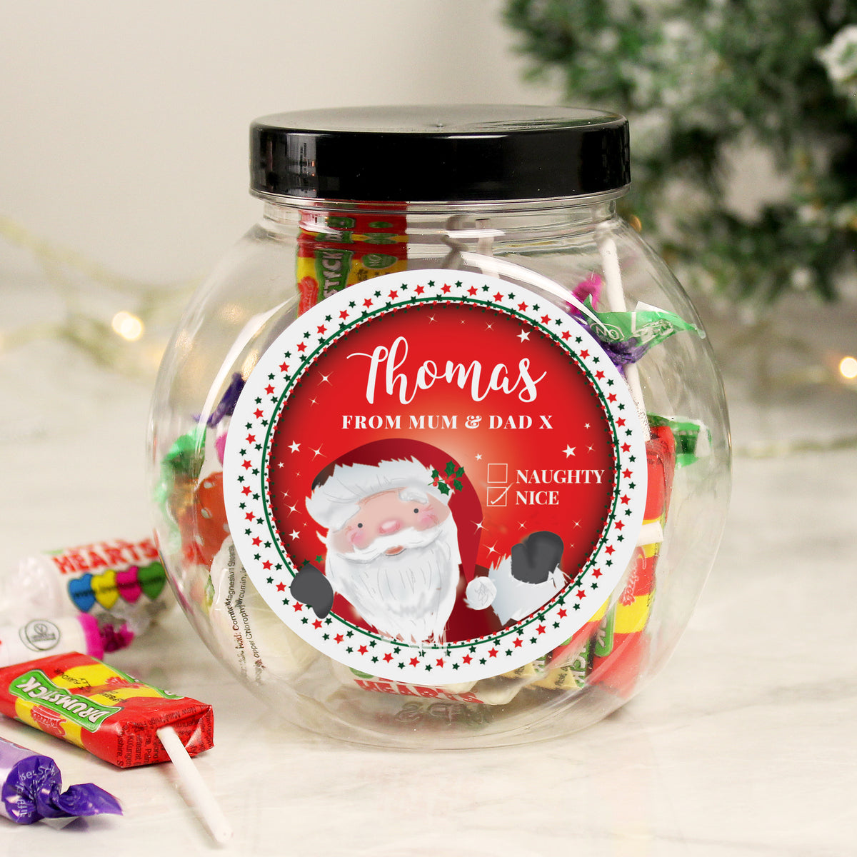 Personalised Santa Naughty or Nice sweet jar filled with sweets by the Christmas tree