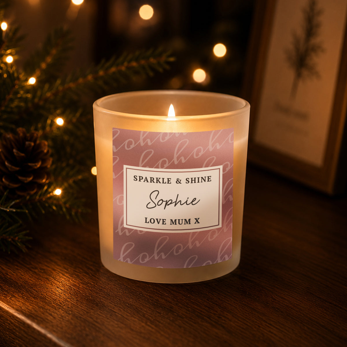Personalised Ho Ho Ho Christmas candle jar with a dusky pink label on a wooden shelf
